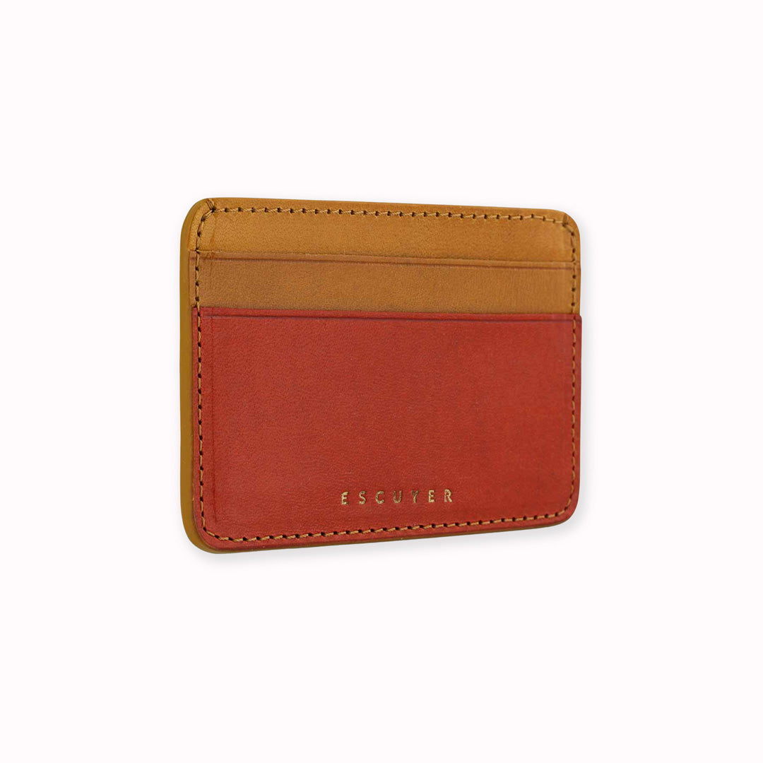 Sideways view of elegant leather cardholder from Escuyer, featuring orange and mustard vegetable dyed colour tones for a stylish and bright appearance. Handmade by Portuguese artisans using leather from a tannery in Tuscany, Italy.