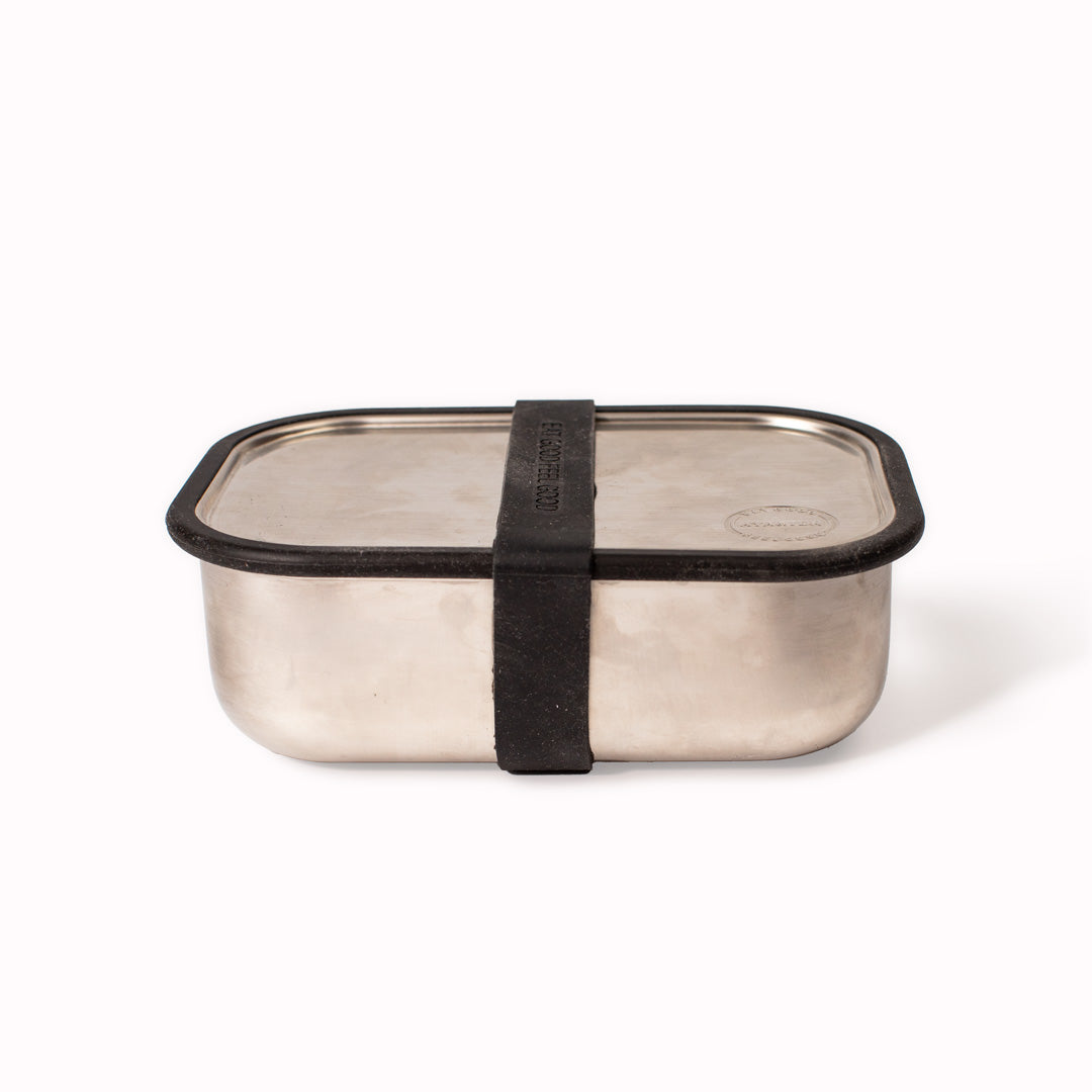Matte Black Lunch Box sideways view by Danish brand AYA &IDA. Created from 100% food grade stainless steel, is perfect for the school bag or on the go with its adjustable divider and silicone edges making this an extremely practical lunch container.