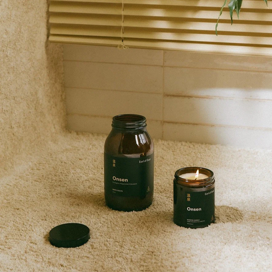 Onsen Candle with bath salts on shelf by Earl of East, An uplifting blend of peppermint, eucalyptus and mandarin, Onsen is inspired by the hot springs of Japan.