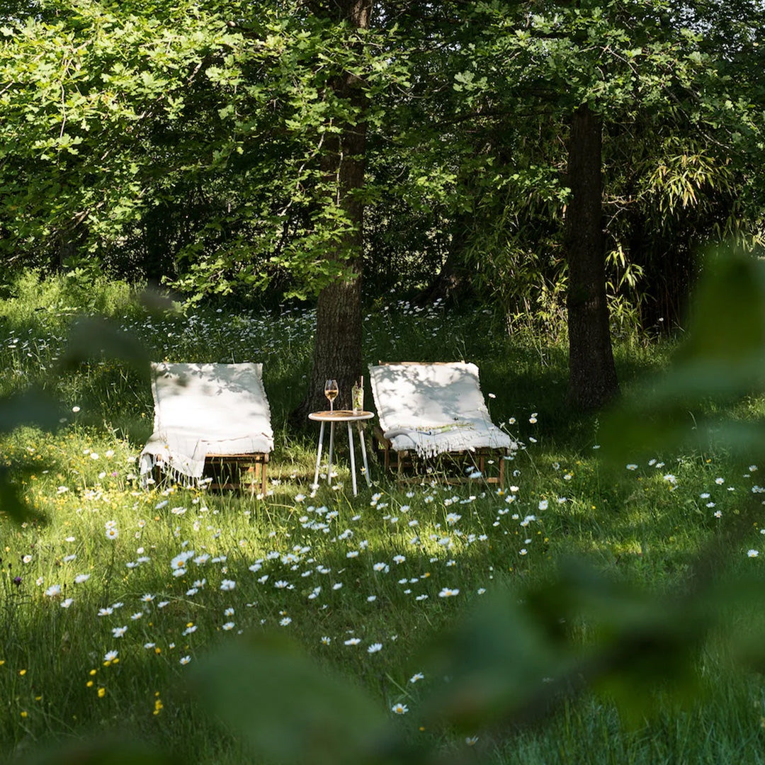 Blanketed lounging chairs in wood image Slow Escapes from Gestalten, explore a new generation of hotels, guesthouses, and hospitality venues that have traded the bustle of cities for the peace of remote and regional areas.