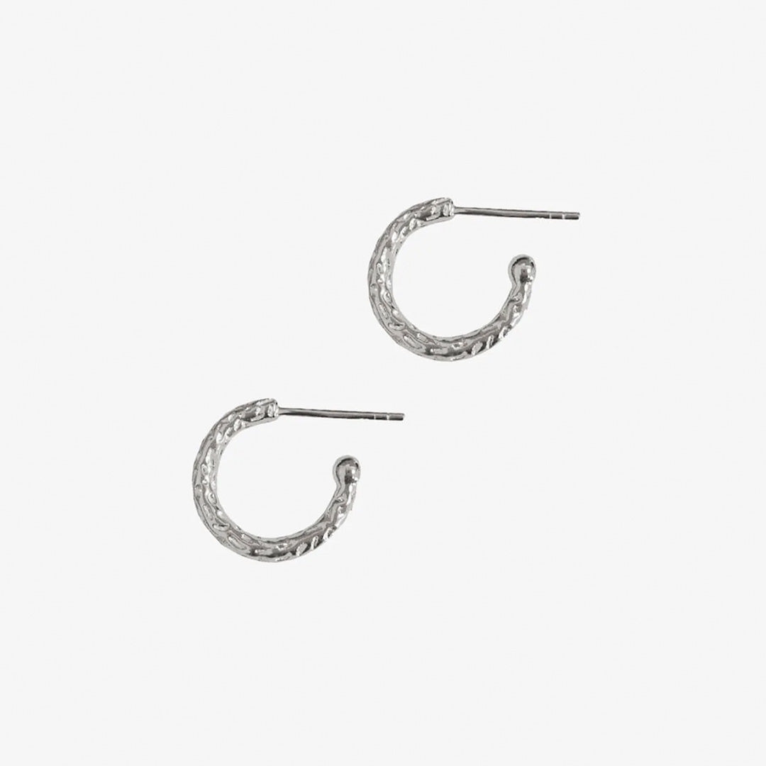 The Textured Huggy Hoops are an essential, classic addition to the Matthew Calvin collection. Designed with stud backs, and featuring high-polish beaded detail, these hoops sit snugly on the ear. Featuring Matthew Calvin's signature Meteorite inspired hand-texturing, the Textured Huggy Hoops catch the light from all angles. 